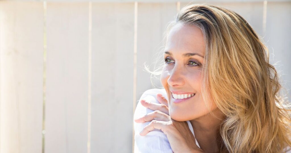 woman smiles after practicing summer dental hygiene