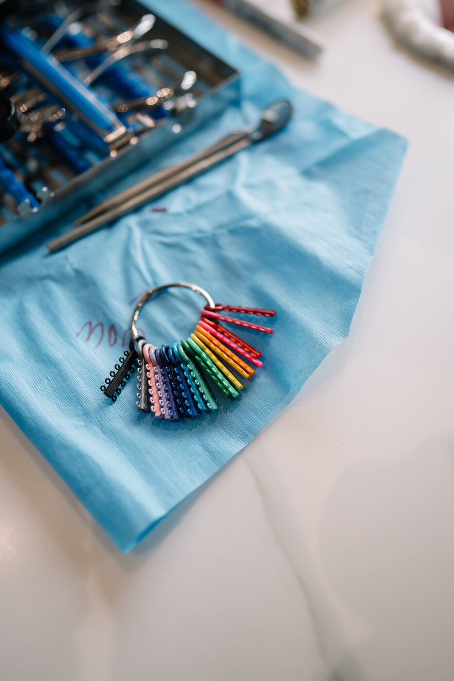 Patient with colorful braces ties at Rogers & Andrews Orthodontics