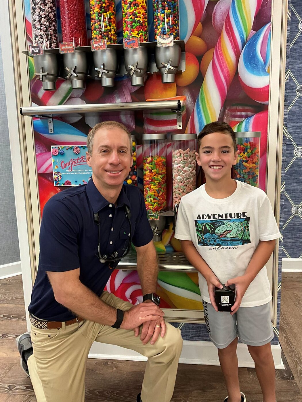 Dr. Andrews with a young patient at the candy wall