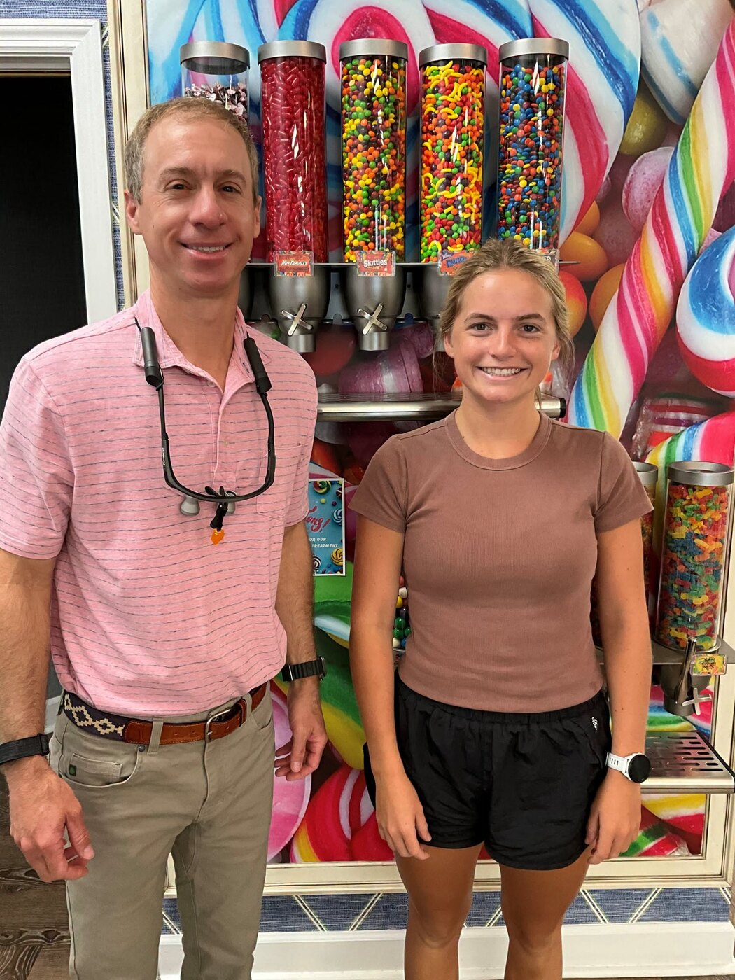 Dr. Andrews with a patient by the candy wall