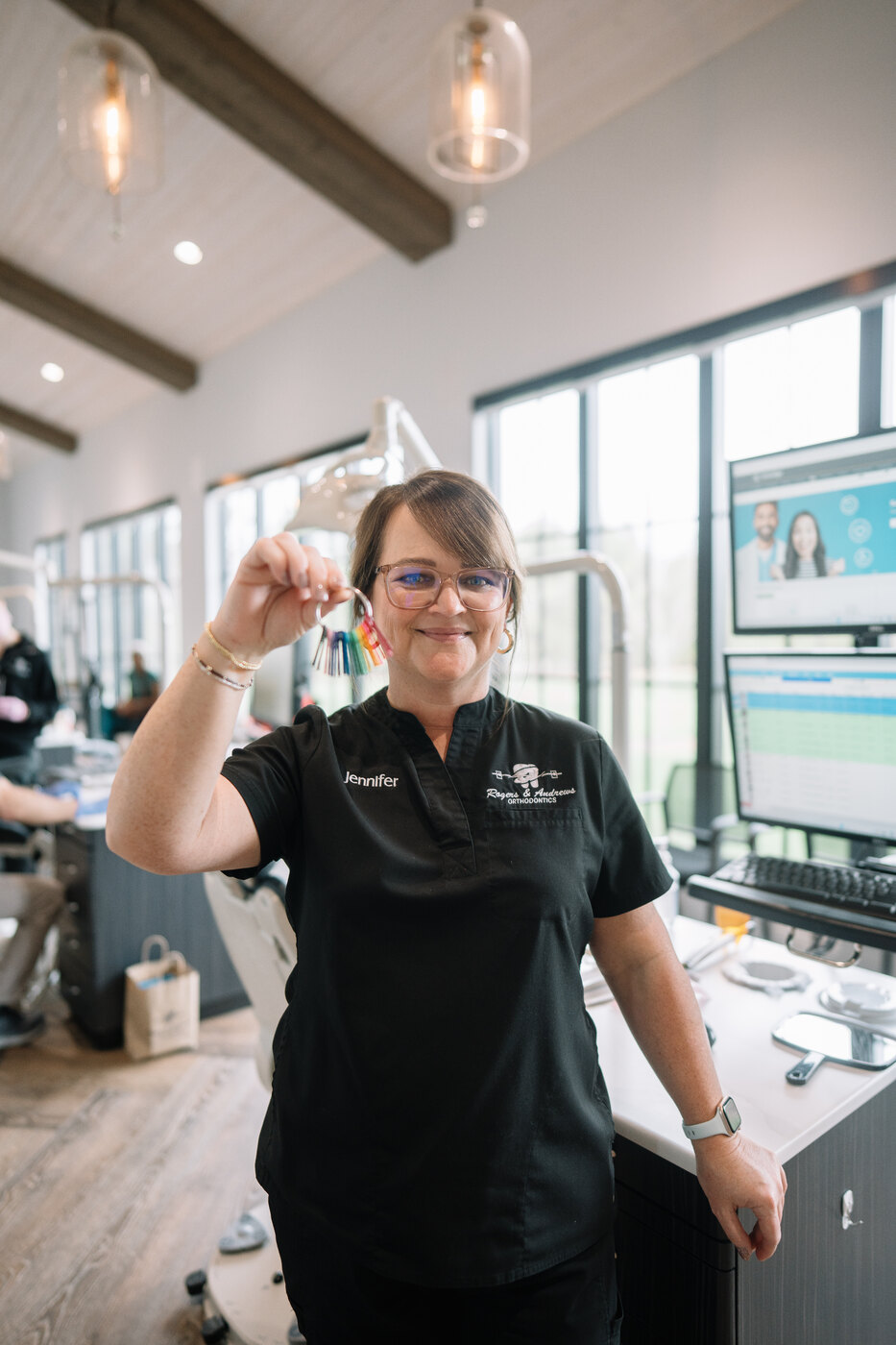 A Rogers & Andrews team member showing braces color options