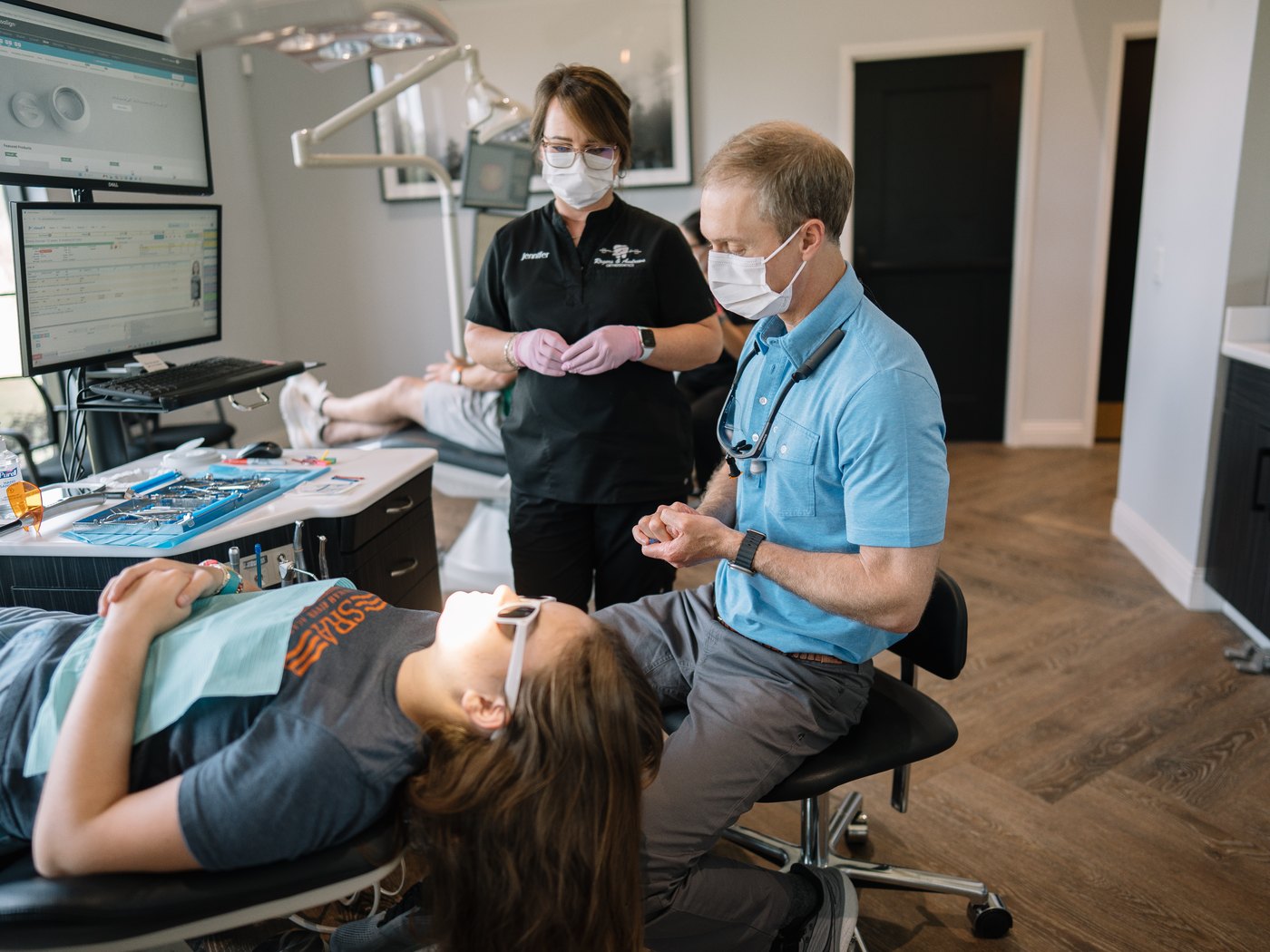 Dr. Andrews and team member treating a teen patient with Invisalign at Rogers & Andrews Orthodontics